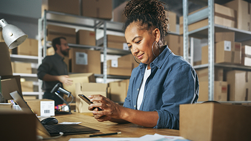 Photo of an inventory manager checking stock and expenses